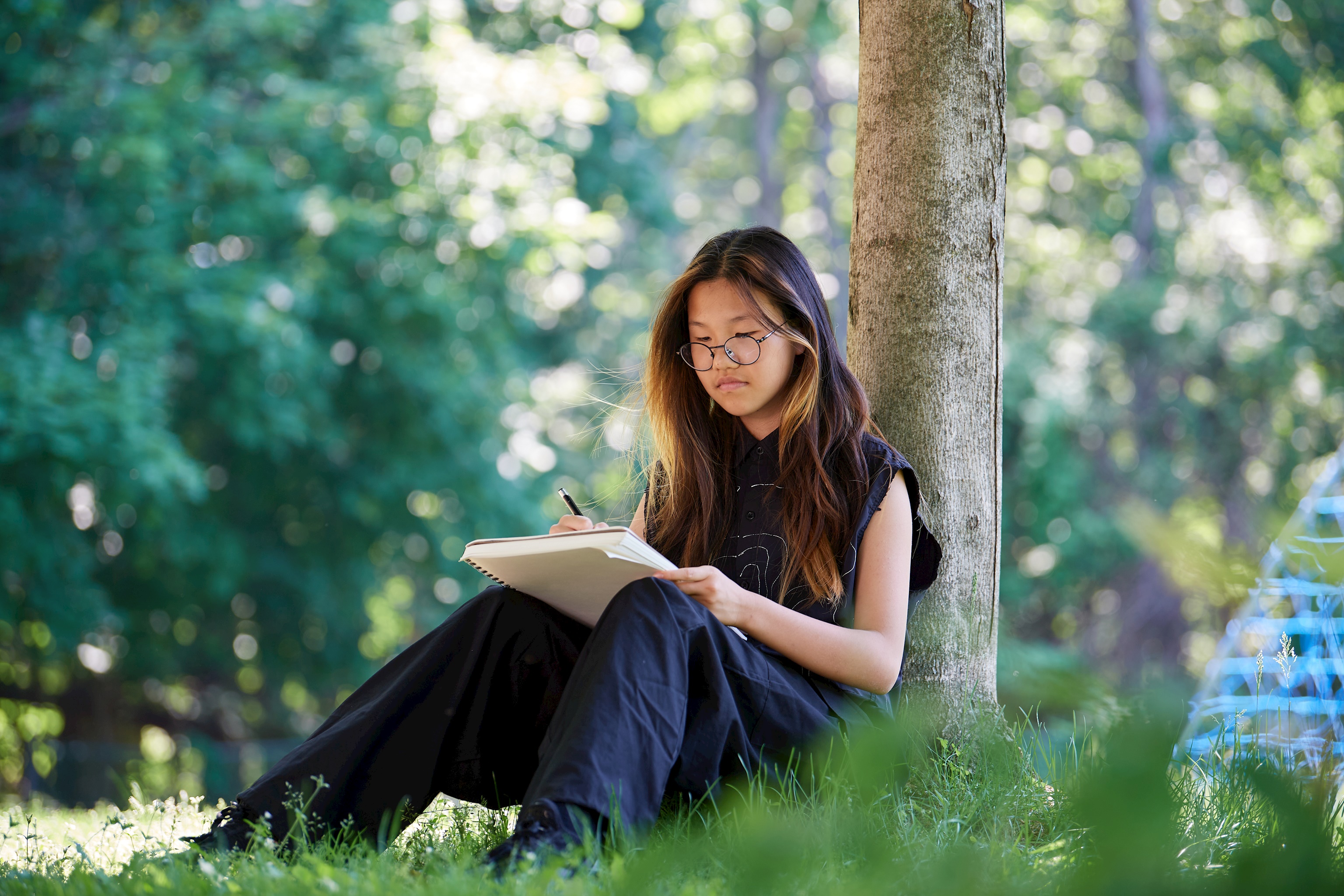 student writing outside private school Applewild