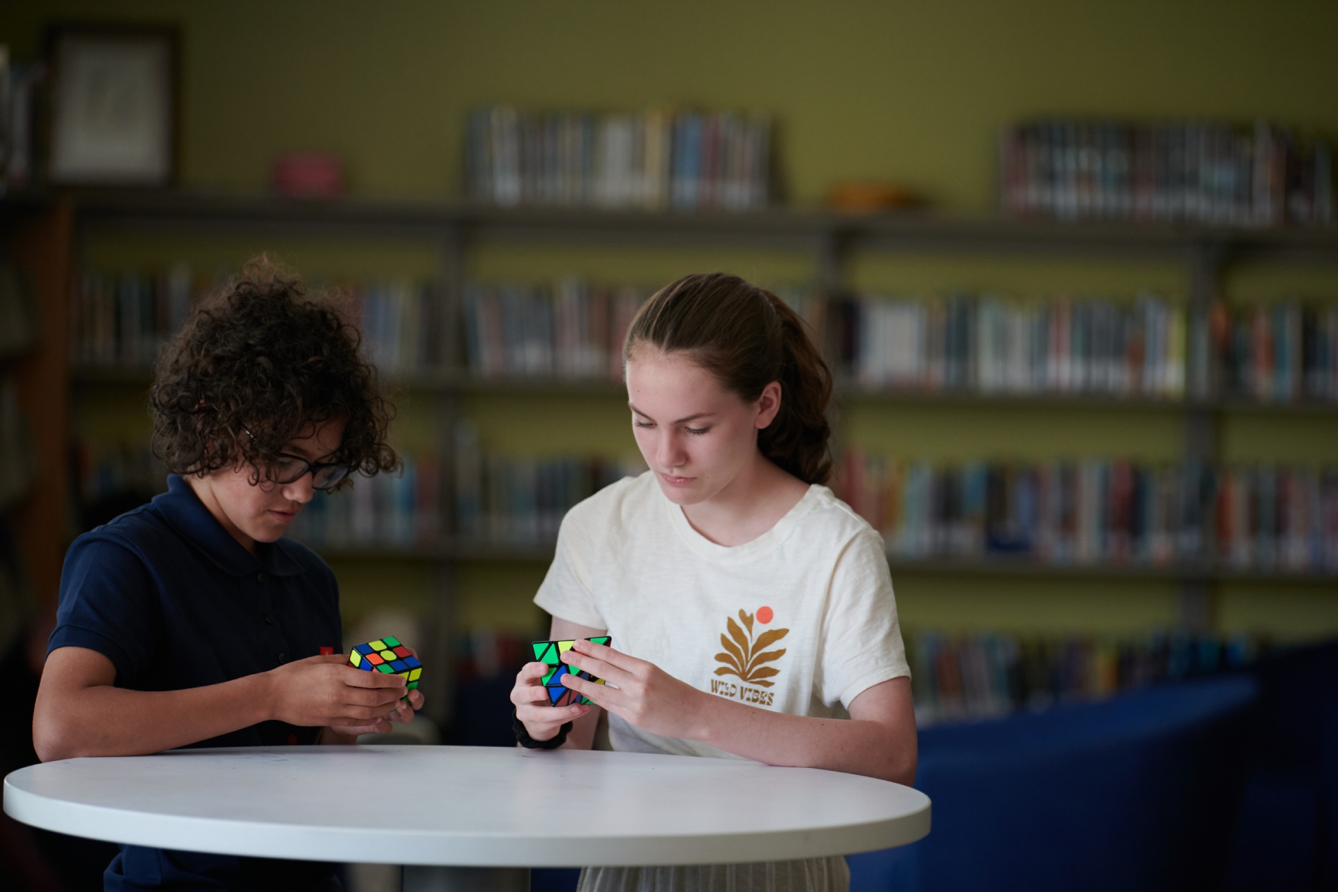 photo of students playiong with rubik cubes
