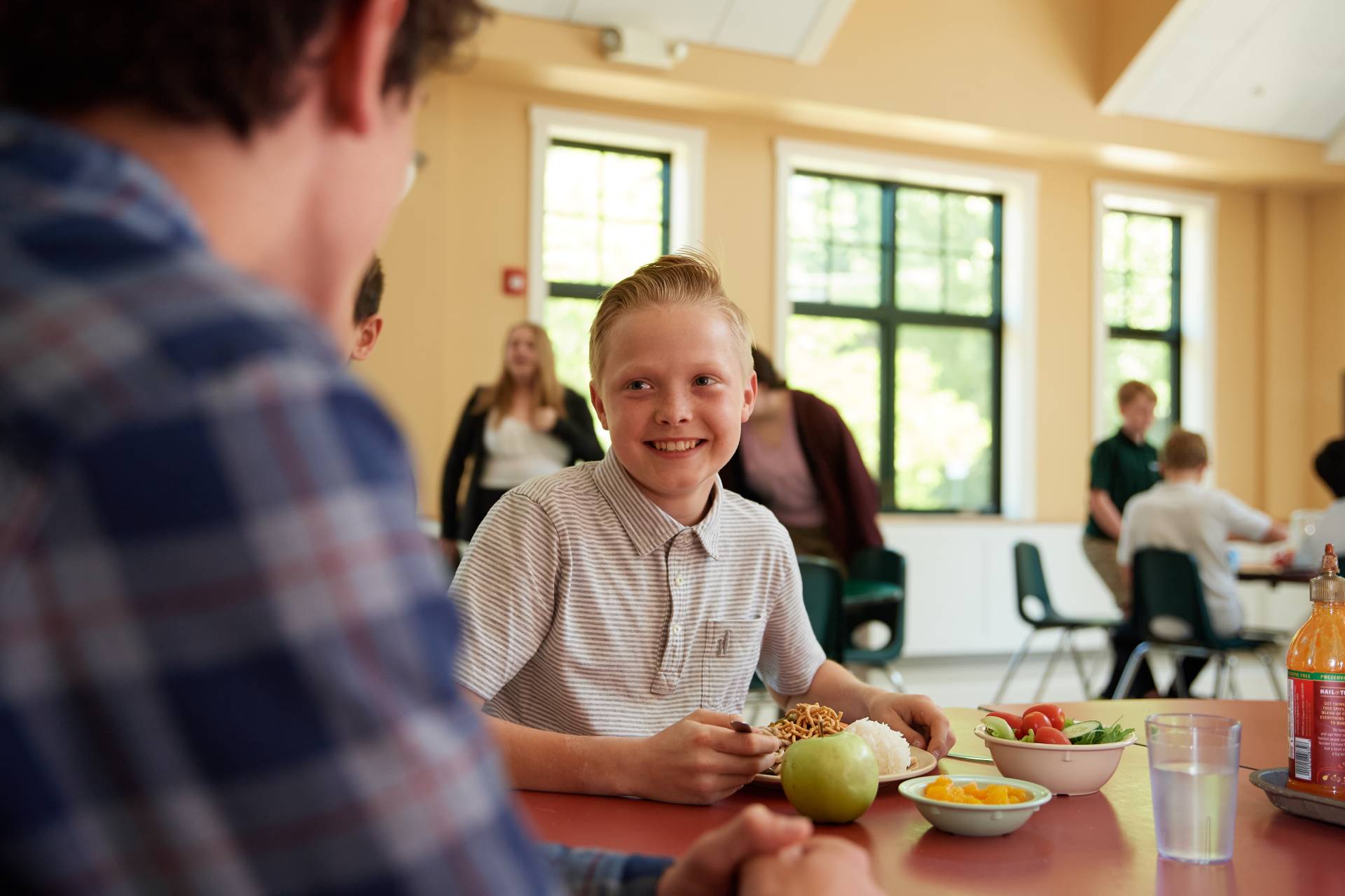 student in school dining area